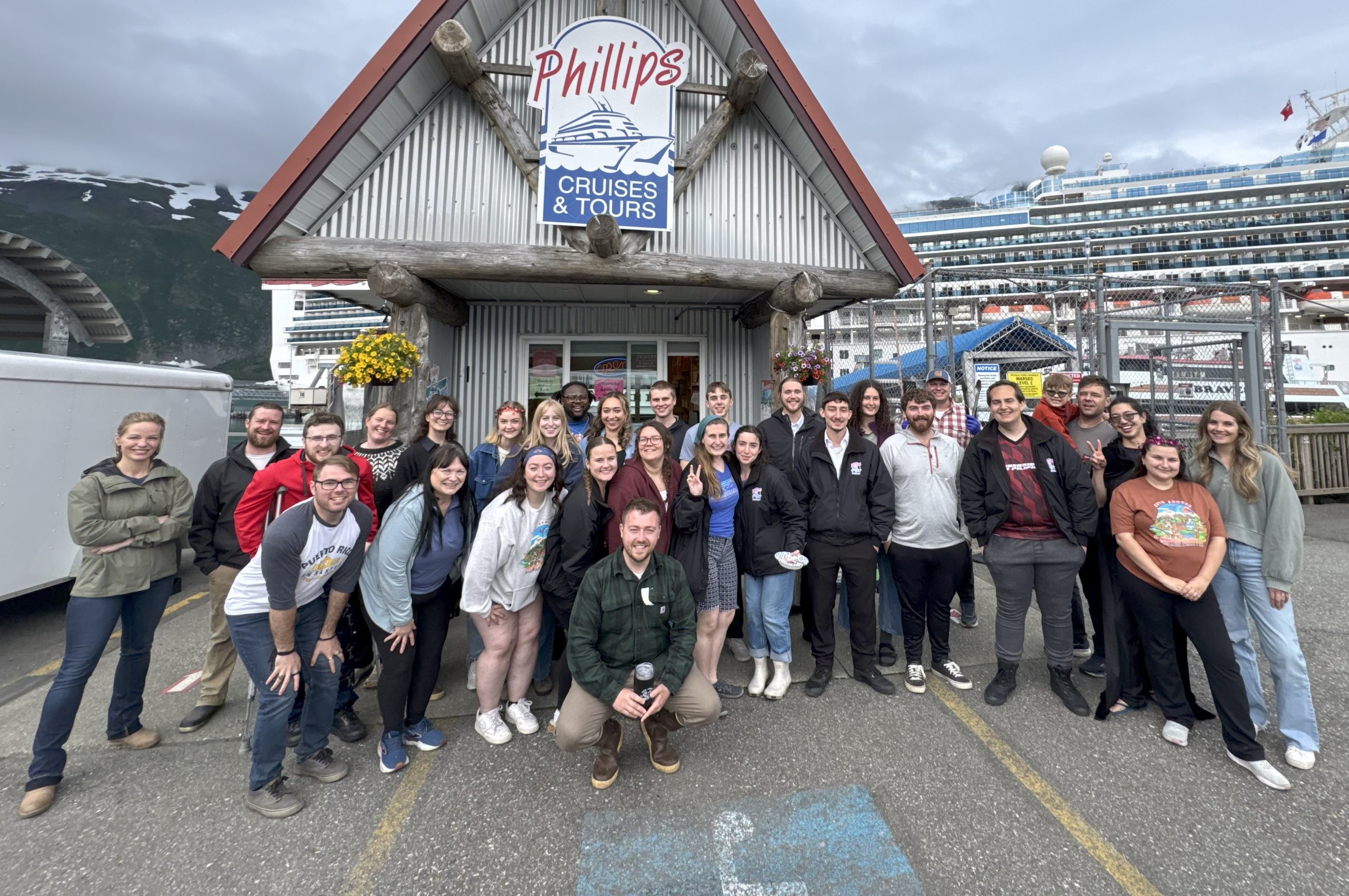 Meet Our Crew Group Shot Crew Photo in front of Kiosk